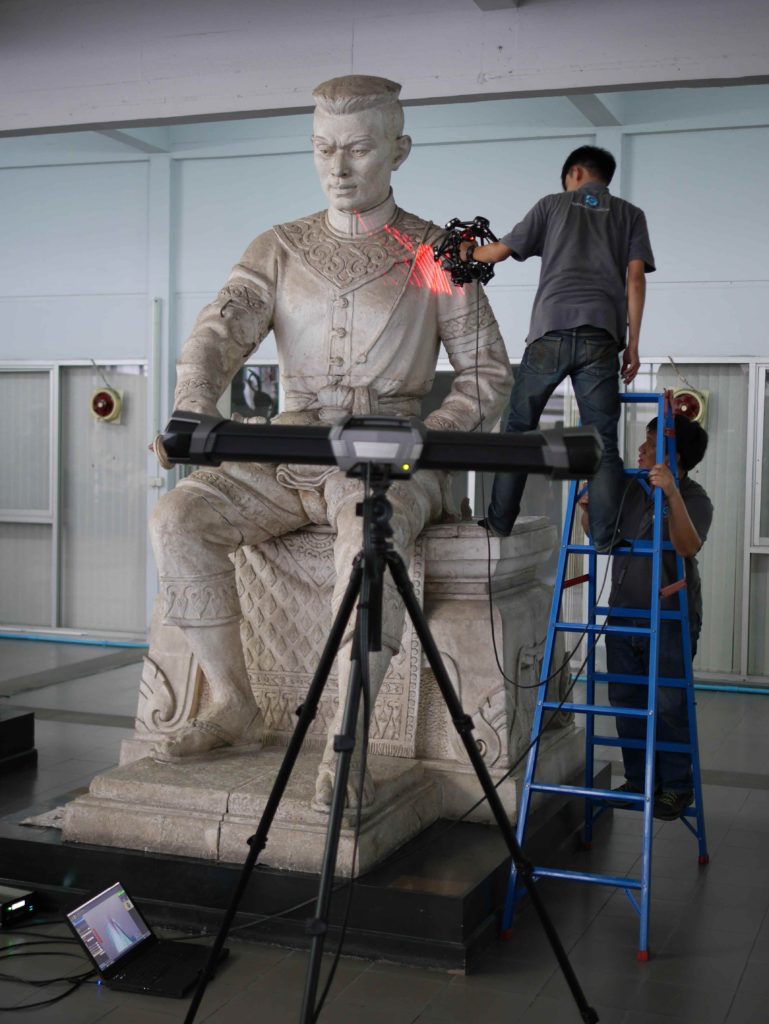 Phu and Fluke up a ladder getting details of the scuplture