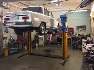 In the seller's private garage shop, changing oil.