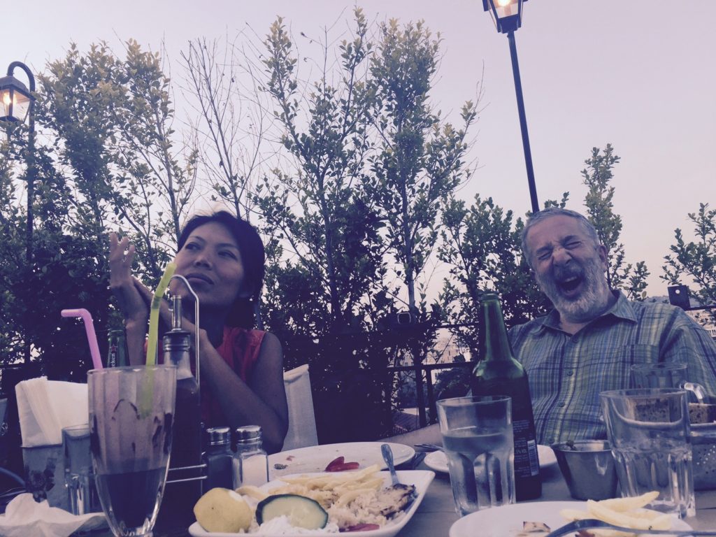 Jake takes picture of mom and dad. Mom looking romantically at the Acropolis, and dad?