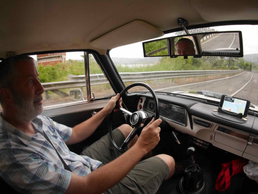 Raining. 'I've been driving all night, my hands 're wet on the wheel.'