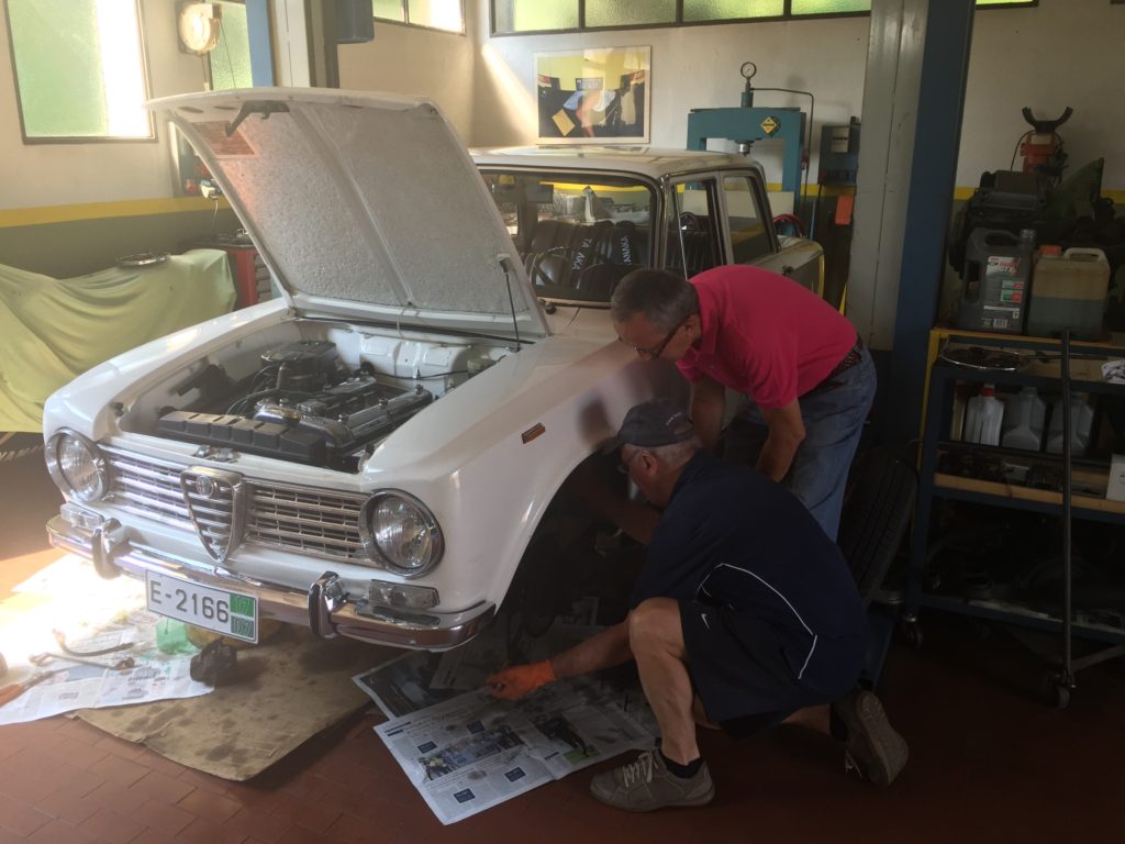 Mario and Enrico wrestle the front brake disk off the axle.