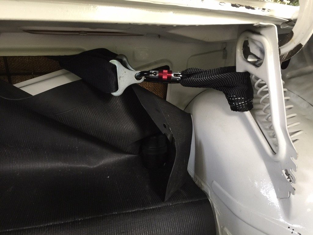 Shoulder straps attached firmly to the car. Cloth straps rated at 10,000 lbs.