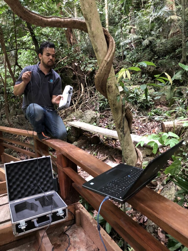 Ek strikes a pose, balancing with the Artec Eva 3D scanner.