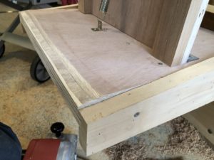 The extra 3/4" plywood brutally beveled with a belt sander.